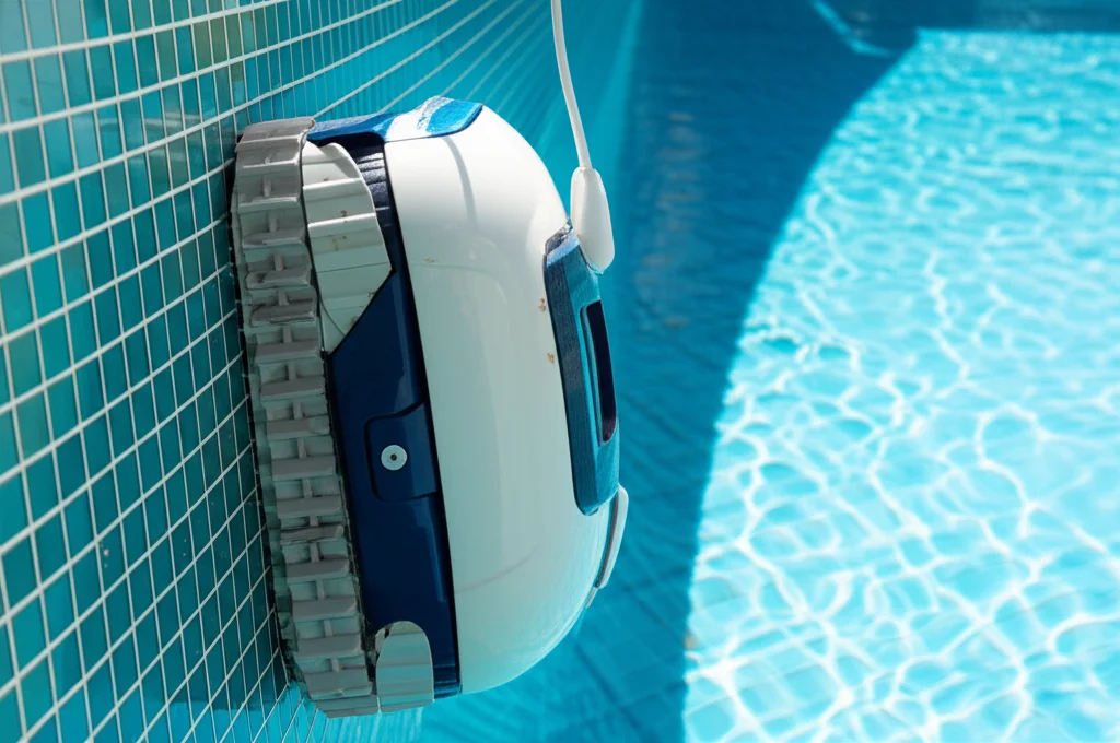 Close-up image of a robotic pool cleaner expertly climbing the tiled walls of a San Antonio pool, removing stubborn alga